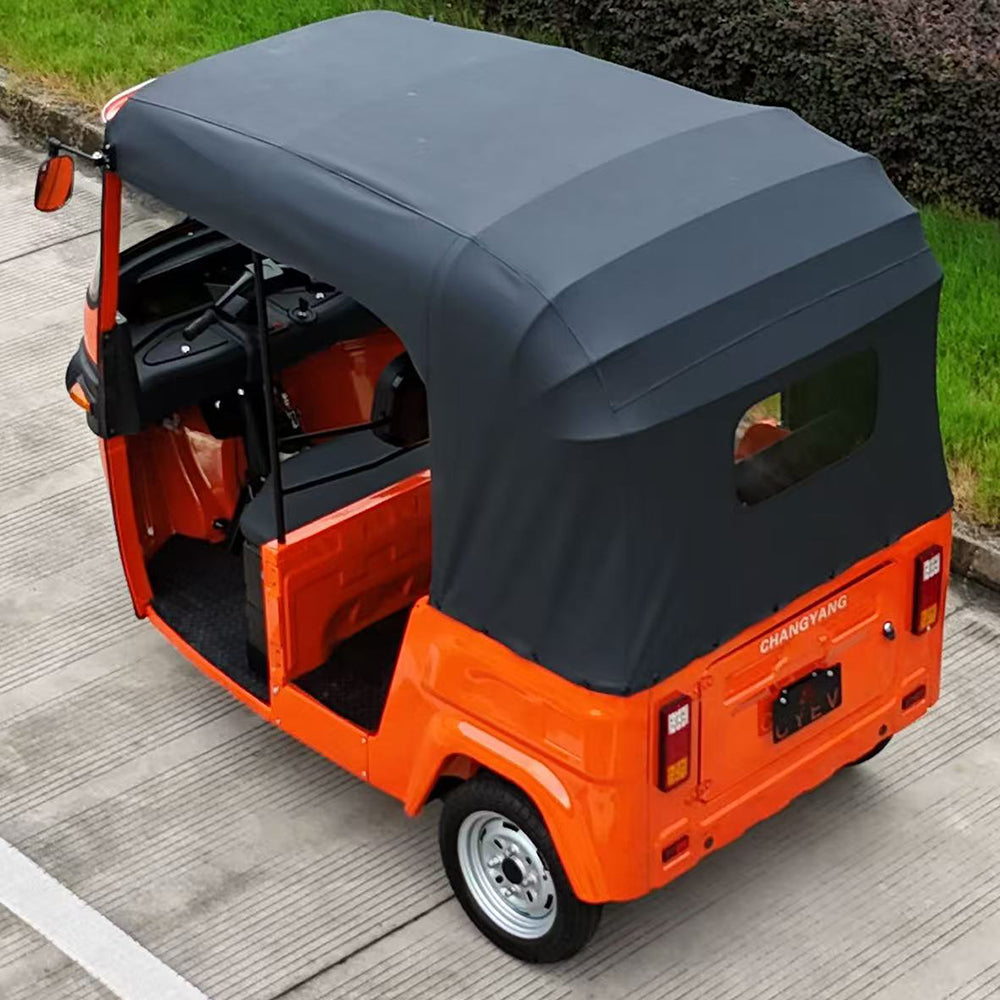 Orange electric cabin tricycle for passengers